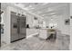 Spacious modern kitchen features an island with bar stool seating and stainless steel refrigerator at 2819 Safe Harbor Dr, Tampa, FL 33618