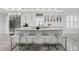 Bright, white kitchen with an island, marble countertops, stainless steel appliances, and wooden floors at 2819 Safe Harbor Dr, Tampa, FL 33618