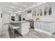 Bright kitchen with marble counters, stainless steel appliances, and sleek white cabinets at 2819 Safe Harbor Dr, Tampa, FL 33618
