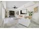 A stylish living room features marble floors, a ceiling fan, and a modern fireplace at 2819 Safe Harbor Dr, Tampa, FL 33618