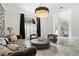 Bright living room with a decorative chandelier, shutters, marble floors and comfortable seating at 2819 Safe Harbor Dr, Tampa, FL 33618