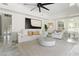 Bright, open living room with modern decor, fan, marble floors and a neutral color palette at 2819 Safe Harbor Dr, Tampa, FL 33618