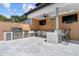 Outdoor kitchen with stainless steel appliances and bar seating, ideal for outdoor dining at 2819 Safe Harbor Dr, Tampa, FL 33618