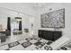 Playroom featuring graphic black and white rug, neutral sofa, with shared view to the living room at 2819 Safe Harbor Dr, Tampa, FL 33618