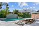 Inviting pool area with multiple lounge chairs, umbrellas, and lush landscaping at 2819 Safe Harbor Dr, Tampa, FL 33618