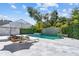 Beautiful pool with stone waterfall feature and poolside seating, a serene backyard oasis at 2819 Safe Harbor Dr, Tampa, FL 33618