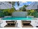 Tranquil poolside view with modern lounge chairs and stylish umbrellas for shade at 2819 Safe Harbor Dr, Tampa, FL 33618