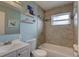 Bathroom with light tile, neutral walls, tiled shower, and white sink and toilet at 3212 34Th N Ave, St Petersburg, FL 33713