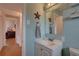 Coastal-themed bathroom featuring blue walls, white vanity, and marine decor accents at 3212 34Th N Ave, St Petersburg, FL 33713