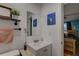 Cozy bathroom with a stylish vanity, nautical themed decor and a glimpse into the adjacent bedroom at 3212 34Th N Ave, St Petersburg, FL 33713