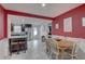 Open-concept dining area with red walls and marble floors adjacent to a modern kitchen at 3212 34Th N Ave, St Petersburg, FL 33713