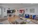 Bright living room featuring hardwood floors, fireplace, and comfortable seating arrangement at 3212 34Th N Ave, St Petersburg, FL 33713
