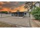 The backyard shows a covered patio with furniture, a paved area, and green landscaping, creating an inviting outdoor space at 3212 34Th N Ave, St Petersburg, FL 33713