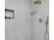 Modern bathroom with gold fixtures and decorative niche at 3381 19Th Sw Pl, Largo, FL 33774