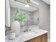 Beautiful bathroom vanity with white marble countertop, dark wood cabinets, and gold fixtures at 3381 19Th Sw Pl, Largo, FL 33774