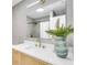 Modern bathroom with bright vanity, white countertop, and sleek gold fixtures at 3381 19Th Sw Pl, Largo, FL 33774