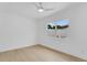 Bright bedroom featuring light wood floors and a ceiling fan at 3381 19Th Sw Pl, Largo, FL 33774