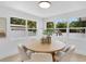 Light-filled dining room featuring a round table with six chairs and multiple windows at 3381 19Th Sw Pl, Largo, FL 33774