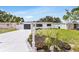 Charming home with a well-maintained front yard, grey garage door, and modern mailbox at 3381 19Th Sw Pl, Largo, FL 33774