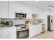 Modern kitchen featuring white cabinets, stainless steel appliances, and a stylish subway tile backsplash at 3381 19Th Sw Pl, Largo, FL 33774