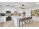 Bright kitchen features white cabinets, stainless steel appliances, and a large island with seating at 3381 19Th Sw Pl, Largo, FL 33774