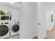 Well-lit laundry room with modern washer and dryer, and neutral color palette at 3381 19Th Sw Pl, Largo, FL 33774