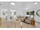 Bright living room with stylish furniture, light wood floors and a view into the dining area at 3381 19Th Sw Pl, Largo, FL 33774