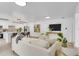 Bright and airy living room showcasing the open floor plan to the kitchen and neutral decor at 3381 19Th Sw Pl, Largo, FL 33774
