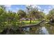 Scenic view of a playground along a waterfront, surrounded by green foliage and a calm canal at 3415 Overlook Ne Dr, St Petersburg, FL 33703