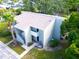 Overhead view of a condo building with a private balcony, surrounded by mature trees and green space at 401 Windrush Bay Dr, Tarpon Springs, FL 34689
