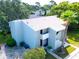 Aerial view of a condo complex, showcasing the well-maintained grounds and proximity to surrounding trees at 401 Windrush Bay Dr, Tarpon Springs, FL 34689