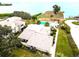An aerial view of the community pool and neighborhood near the water and beach at 401 Windrush Bay Dr, Tarpon Springs, FL 34689