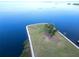 A serene aerial view of a green waterfront property and the calm bay at 401 Windrush Bay Dr, Tarpon Springs, FL 34689