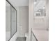 Well-maintained bathroom with a glass-enclosed shower and neutral tile at 401 Windrush Bay Dr, Tarpon Springs, FL 34689