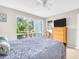 Bright bedroom with a large window and neutral walls and floors at 401 Windrush Bay Dr, Tarpon Springs, FL 34689