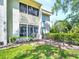 The exterior showcases the building's architecture and the property's well-manicured landscaping at 401 Windrush Bay Dr, Tarpon Springs, FL 34689