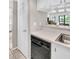 Bright kitchen with a dishwasher and view into a cozy living area at 401 Windrush Bay Dr, Tarpon Springs, FL 34689