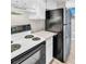 Functional kitchen featuring a white stove, a black refrigerator and bright white cabinetry at 401 Windrush Bay Dr, Tarpon Springs, FL 34689