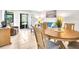 Comfortable living area featuring a dining table, cozy seating, and sliding glass doors to the outdoors at 401 Windrush Bay Dr, Tarpon Springs, FL 34689
