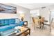 Comfortable living area with a blue sofa, glass coffee table, and round dining table with chairs at 401 Windrush Bay Dr, Tarpon Springs, FL 34689