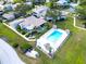 Aerial view of the community pool area, highlighting the ample seating and surrounding greenery at 401 Windrush Bay Dr, Tarpon Springs, FL 34689