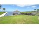 A view of the waterfront with a gazebo and walkway surrounded by green grass and plants at 401 Windrush Bay Dr, Tarpon Springs, FL 34689