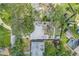 Overhead view showcasing the property's layout, including the house, backyard, and lush surrounding landscape at 412 Mira Vista Dr, Dunedin, FL 34698