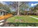 Lush backyard featuring a deck, pergola, and mature trees, offering a private and inviting outdoor retreat at 412 Mira Vista Dr, Dunedin, FL 34698