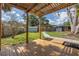 Spacious backyard showing a wooden deck and pergola, complemented by lush greenery and a serene atmosphere at 412 Mira Vista Dr, Dunedin, FL 34698