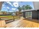 Large wooden deck with built-in seating overlooking the landscaped backyard at 412 Mira Vista Dr, Dunedin, FL 34698