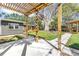 Inviting backyard showcasing a pergola, deck, and paved walkway, enhancing the outdoor living experience at 412 Mira Vista Dr, Dunedin, FL 34698