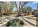 A beautiful backyard featuring patios and mature trees, and pergola at 412 Mira Vista Dr, Dunedin, FL 34698