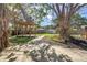 Outdoor backyard features mature trees, a pergola and green space at 412 Mira Vista Dr, Dunedin, FL 34698