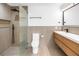 Modern bathroom featuring a glass-enclosed shower, neutral walls, and a wooden vanity at 412 Mira Vista Dr, Dunedin, FL 34698